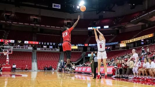Julie Pospisilova shoots a three point shot.