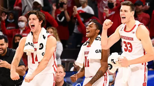 LAS VEGAS, NV - NOVEMBER 22: Wisconsin Badgers forward Carter Gilmore (14), Wisconsin Badgers guard Lorne Bowman II (11) and Wisconsin Badgers center Chris Vogt (33) celebrate on the bench during the first round college basketball game in the Maui Invitational between the Texas A&M Aggies and the Wisconsin Badgers on November 22, 2021, at the Michelob ULTRA Arena in Las Vegas, NV. The tournament was moved from Maui due to COVID-19 concerns. (Photo by Brian Rothmuller/Icon Sportswire)