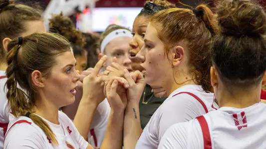 The Badgers huddle up on the court.