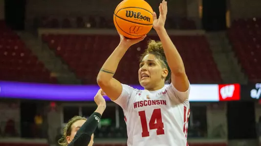 Krystyna Ellew shoots over a Virginia Tech defender.