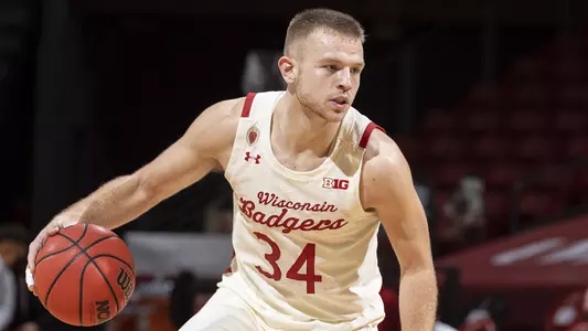 Wisconsin Badgers guard Brad Davison (34) handles the ball during an NCAA college basketball game against the Louisville Cardinals, December 19, 2020, in Madison, Wis. The Badgers won 85-48. (Photo by David Stluka/Wisconsin Athletic Communications)