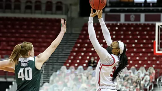 Imani Lewis shoots over a Michigan State defender