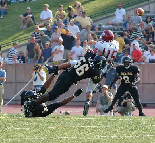 Joe Suiter sacking quarterback while playing football at Appalachian State. Suiter is No. 56.
