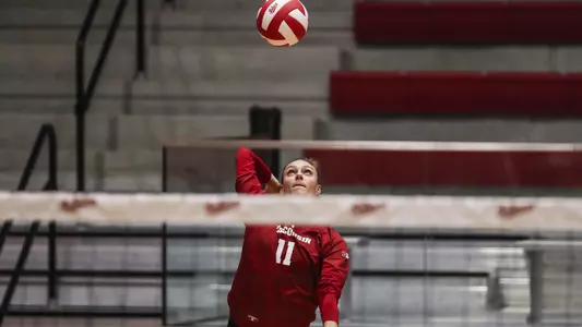 Izzy Ashburn serves up the ball.