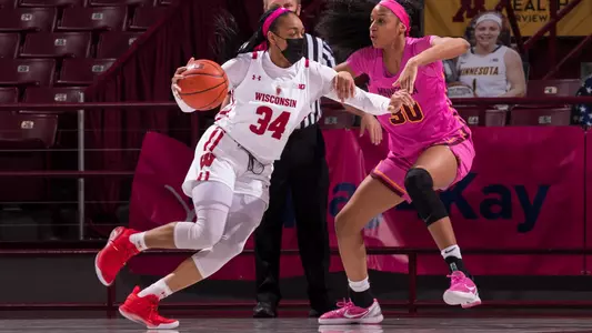 Imani Lewis drives around a Minnesota defender.