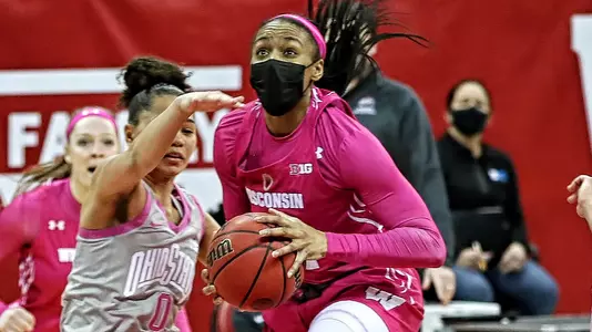 Imani Lewis drives to the basket between two Ohio State defenders.