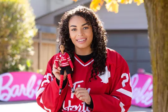 Sarah Nurse with her Barbie Doll - There are two Tim Hortons Hockey Barbie dolls to choose from, which come with a Tim Hortons hockey jersey, helmet, hockey stick, a doll stand and Certificate of Authenticity. The Tim Hortons Hockey Barbie makes a great gift for collectors and kids aged six years and up and sells for $29.99. (CNW Group/Tim Hortons)