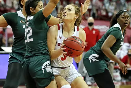 Brooke Schramek battles past several MSU defenders.