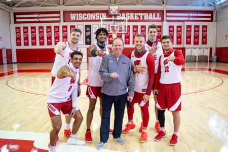 Men's basketball seniors with coach Greg Gard and 2020 Big Ten Championship rings - Micah Potter, D'Mitrik Trice, Brad Davison, Aleem Ford, Trevor Anderson