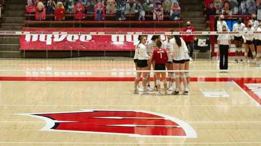 The Badgers huddle up on the court.