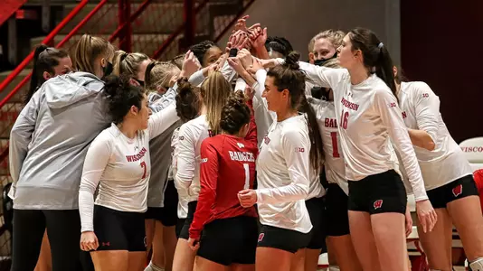 The Badgers huddle up on the sideline before the start of a match.