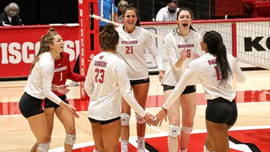 The Badgers celebrate a point during the match.