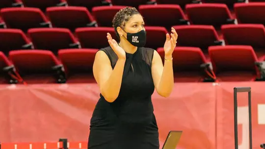 Marisa Moseley claps for her team from the sidelines