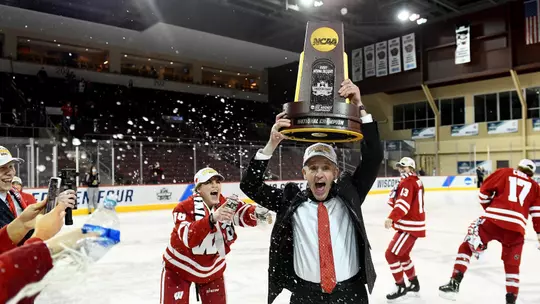 Head Coach Mark Johnson of the Wisconsin Badgers celebrates following the Badgers 2-1 win over the Northeastern Huskies in overtime during the Division I Women’s Ice Hockey Championship held at Erie Insurance Arena on March 20, 2021 in Erie, Pennsylvania. (Photo by Justin Berl/NCAA Photos/NCAA Photos via Getty Images)