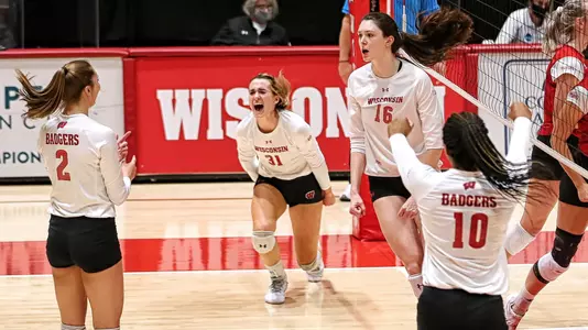 The Badgers celebrate a point during the match.