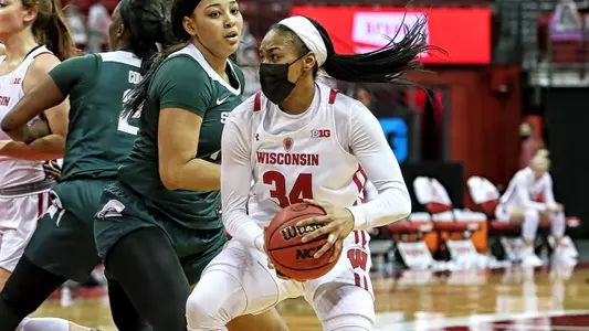Imani Lewis drives to the basket around a Michigan State defender.