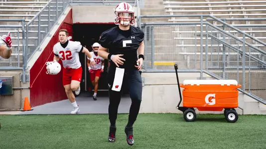 Graham Mertz runs out of the tunnel inside Camp Randall Stadium for Wisconsin spring practice 2021