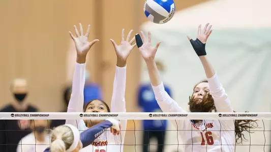 Devyn Robinson and Dana Rettke block a BYU attack.