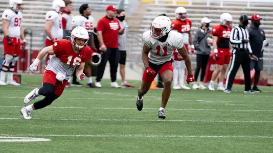 Wisconsin wide receiver Jack Dunn (16) and corner back Alexander Smith (11) training at spring football practice inside Camp Randall Stadium