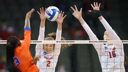Sydney Hilley and Dana Rettke go up for a block against a Florida hitter.