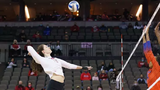 Dana Rettke hits against two Florida blockers