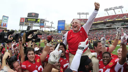 Barry Alvarez is carried on the shoulders of Wisconsin football players celebrating after the 2015 Outback Bowl