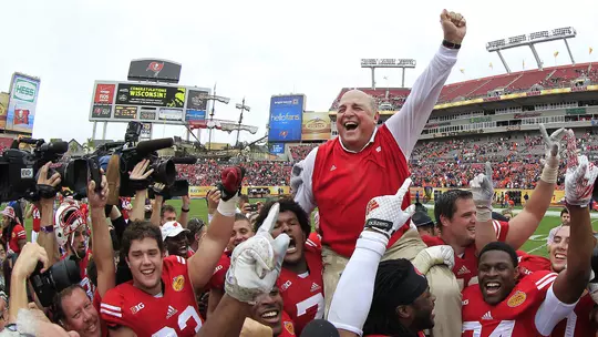 Barry Alvarez is carried on the shoulders of Wisconsin football players celebrating after the 2015 Outback Bowl