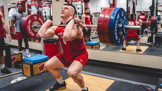 Wisconsin football inside linebacker Leo Chenal lifts weight during team training