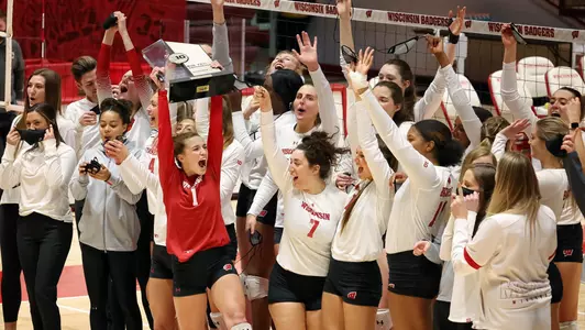 The Badgers hold up the 2020 Big Ten trophy.