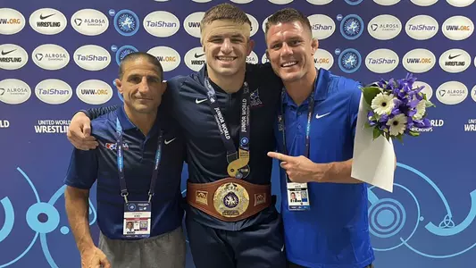 Braxton Amos (center) with Wisconsin wrestling head coach Chris Bono (left) and associate head coach Jon Reader (right) at the 2021 Junior World Wrestling Championships in Ufa, Russia