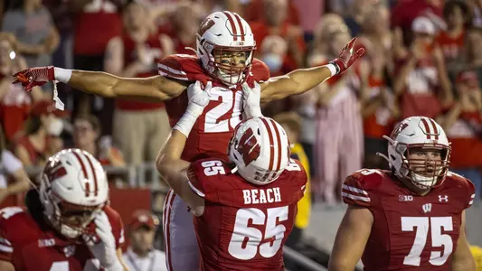 Wisconsin Badgers running back Isaac Guerendo (20) celebrates his first career touchdown with teammates during an NCAA college football game against the Eastern Michigan Eagles Saturday, Sept. 11, 2021, in Madison, Wis. The Badgers won 34-7. (Photo by David Stluka/Wisconsin Athletic Communications)