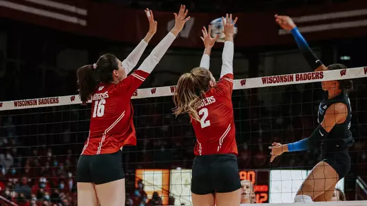 Dana Rettke and Sydney Hilley go up for a block against a Kentucky hitter.