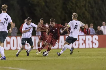 Finnegan dribbles between a pair of Spartan defenders at McClimon Friday night