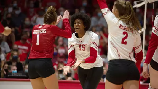 Jade Demps celebrates with teammates on the court.