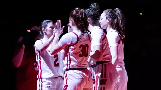 The Badger starters slap hands during starting lineup announcement.