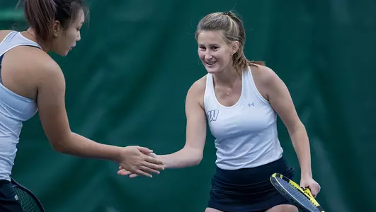 Badgers celebrate during doubles practice