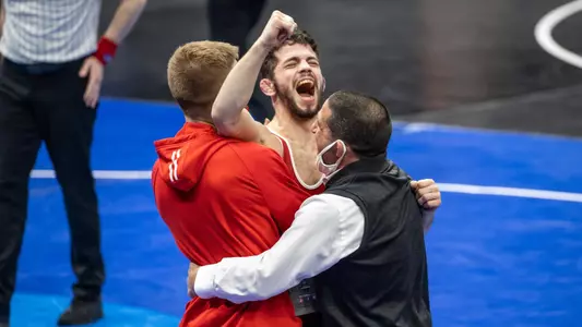 Eric Barnett, wisconsin wrestling, celebrates with coaches Chris Bono and Seth Gross after earning All-America honors for the first time in his collegiate career at the 2021 NCAA Division I Wrestling Championships in Saint Louis, Missouri. Photo by Stacy Schiesl.