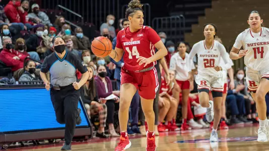 Krystyna Ellew brings the ball up the court.