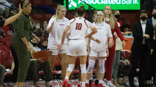 Halle Douglass receives high fives from the Badger bench.