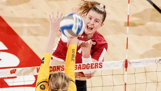 Sarah Franklin attacks the ball against a Michigan blocker.