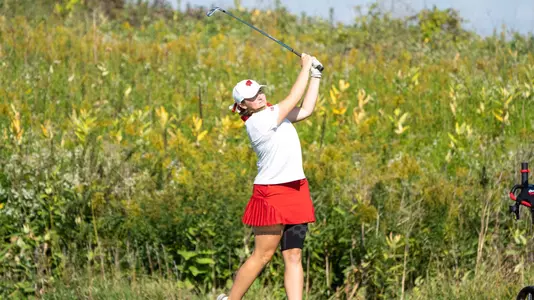 Emily Lauterbach of Wisconsin women's golf finishes a swing at the 2022 Badger Invitational