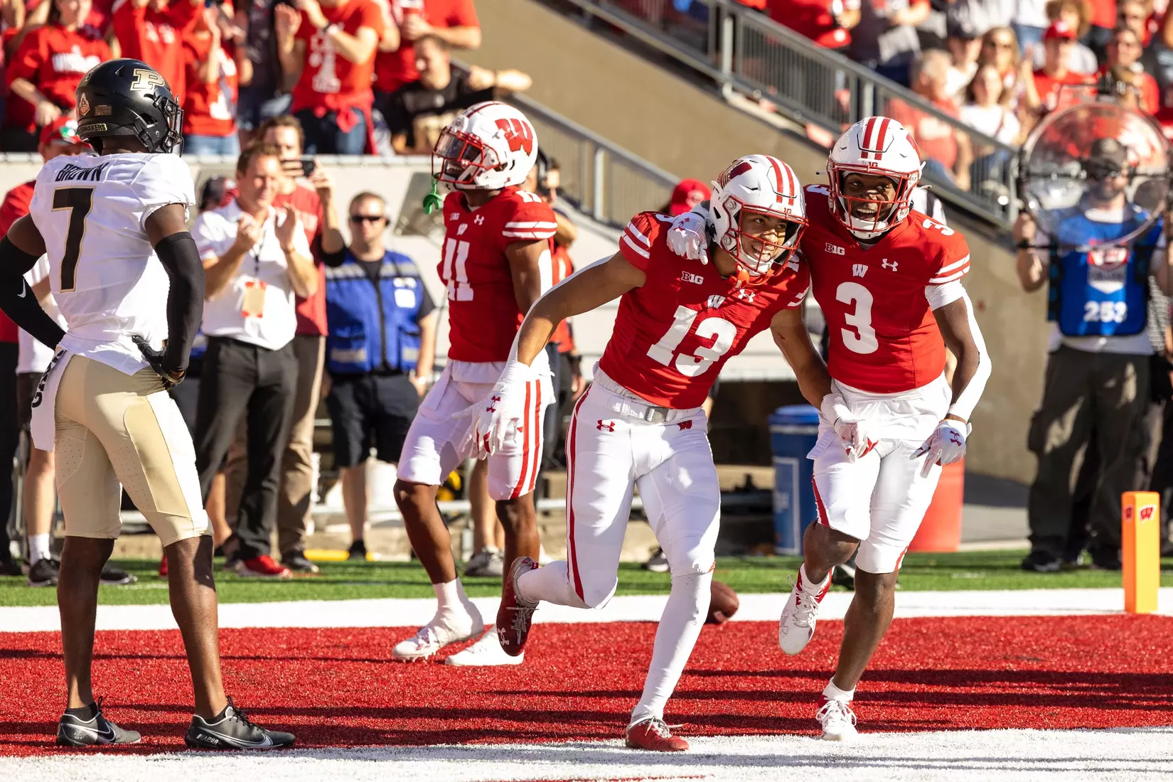 Wisconsin Badgers wide receiver Chimere Dike (13) celebrating with T.J. Bollers (3) after Dike's touchdown reception during an NCAA college football game against the Purdue Boilermakers, Saturday, Oct. 22, 2022 in Madison, Wis.