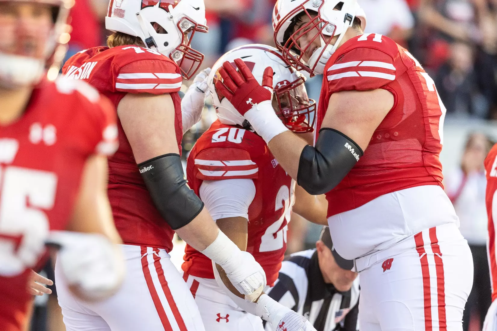 Wisconsin Badgers offensive line Riley Mahlan (71) embraces running back Isaac Guerendo (20) after Guerendo's touchdown run during an NCAA college football game against the Purdue Boilermakers, Saturday, Oct. 22, 2022 in Madison, Wis.