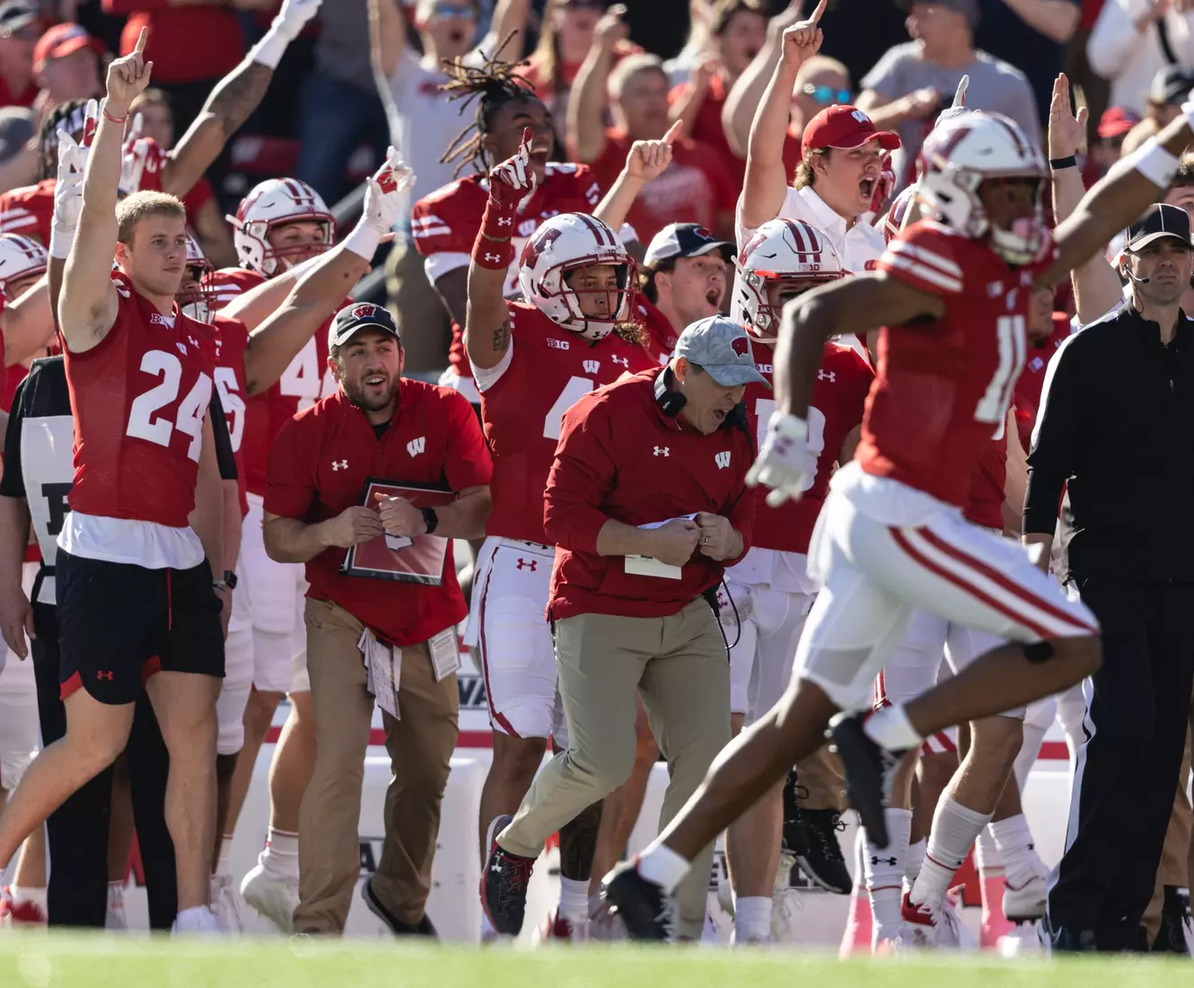 Wisconsin Badgers sideline and center back Alexander Smith (11) celebrate a big play for the team at the start of the second half during an NCAA football game against the Purdue Boilmakers on October 22, 2022 in Madison, WI.