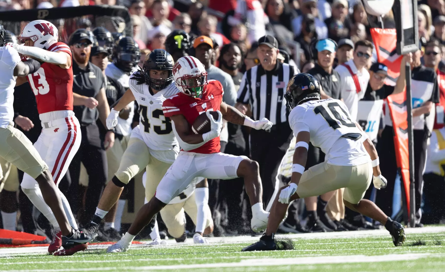 Wisconsin Badgers wide receiver Skyler Bell (11) juking out the Purdue Boilmakers defense to prolong the Badgers drive during an NCAA football game  October 22, 2022 in Madison, WI.