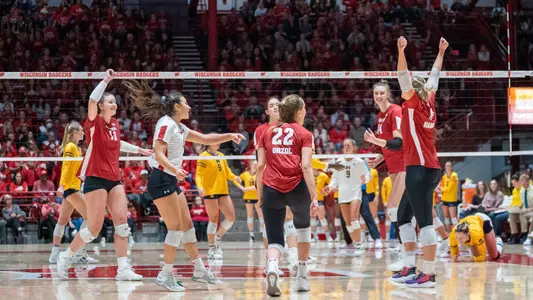 The Badgers celebrate a point on the court.