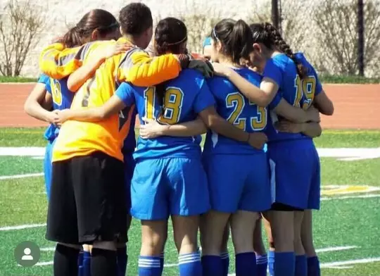 Estafania Zavala, DAT, Wisconsin sports medicine athletic trainer in a team huddle during high school soccer