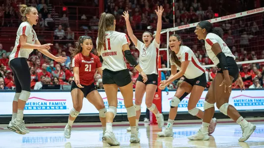 The Badgers celebrate a point on the court.