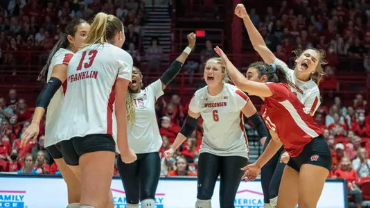The Badgers celebrate a point on the court.