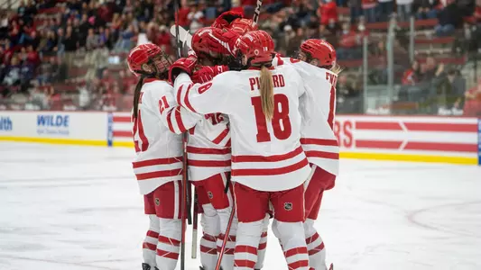 The Wisconsin Badgers women's hockey team celebrates a goal in a game against St. Thomas at LaBahn Arena on October 7th, 2022.